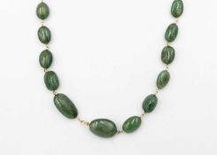 An emerald graduated bead necklace, strung to a silver-gilt lobster clasp.