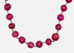 A red dyed quartz long circular bead necklace.