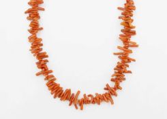A long stick coral necklace.