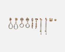 A selection of 9k earrings, including two pairs of blue topaz set drop earrings.