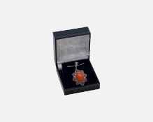 A silver pendant set with an oval cabochon enhanced dyed orange opal, pink tourmalines and diamonds.