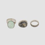 Three silver gem-set rings.