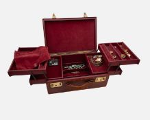 A burgundy leather-covered jewellery box, containing a little costume jewellery.