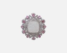 A stylish silver dress ring, set with a carved rainbow moonstone, tourmalines and diamonds.
