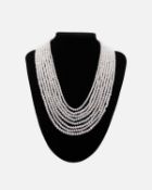 An eight strand white cultured pearl necklace, strung to white base metal CZ set bars and hook clasp