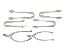 A selection of silver sugar tongs.