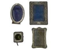 A collection of four silver mounted picture frames.