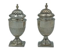 A pair of Victorian silver pepperettes by David & Lionel Spiers.
