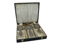 A repoussé silver dressing table set by W. I. Broadway & Co.