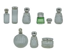 A selection of silver-lidded cosmetic jars and scent bottles.