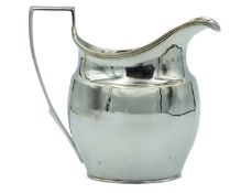 A George III silver helmet-shaped milk jug.