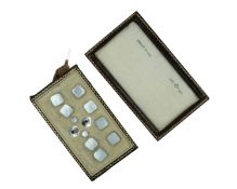 A sterling silver with mother-of-pearl shirt button and cufflink dress set by Owen Powell.