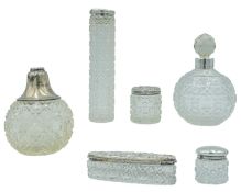 A selection of early twentieth-century silver lidded scent bottles.