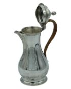 A silver hot water pot by Daniel & John Wellby.