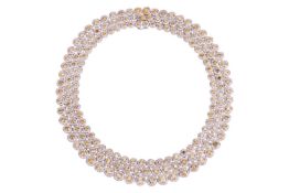 A multicoloured diamond-set three row necklace, featuring yellow, brownish-yellow, orangey-yellow an
