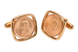 A pair of cufflinks inset with 1/10oz Krugerrands, set in a yellow metal square frame stamped 9ct, G
