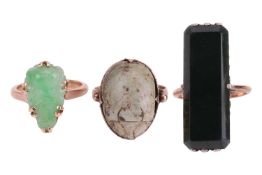 Three gem-set rings; to include an elongated jadeite panel in dark green colour, measuring 3.2 x 1.2