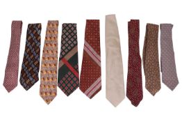A collection of nine designer silk ties; including three Yves Saint Laurent patterned ties, two Herm
