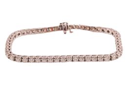 A diamond line bracelet, comprising fifty-two round brilliant-cut diamonds, each measuring approxima