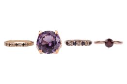 Four gem-set rings; to include a synthetic colour-change sapphire dress ring between bifurcated shou