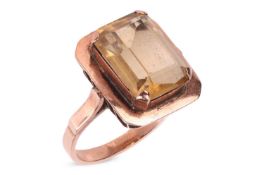 A citrine dress ring, centred with an octagonal step-cut citrine of 13.4mm x 9.9mm x 6.2mm, in a cla