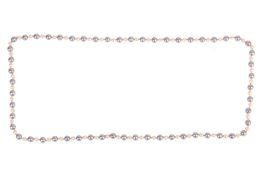 A cultured pearl necklace, comprising a single row of 112 cultured pearls, alternating between cream