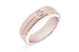 A diamond-set dress ring, flush-set with a round brilliant-cut diamond with an estimated weight of 0