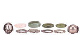 A small collection of rings; to include two carved nephrite bands and a carved jadeite band, four st