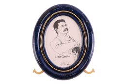 Must de Cartier - A gilt metal photo frame, of oval shape, in blue with golden speckles imitating la