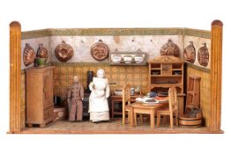 A late 19th or early 20th century doll's house kitchen diorama, complete with two dolls, furniture, 