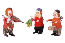 A group of three Schuco felt-covered tinplate clockwork toy, modelled as clowns in red costumes, com