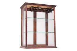 An early 20th century mahogany counter top shop glazed display cabinet, marked 'Kemp's Pharmacy Ltd,