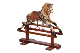 A small wooden toy rocking horse, dapple grey with real horsehair, 86 cm high x 91 cm x 34 cm.