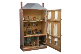 A large German pine dolls house, late 19th century, the painted red brick front with six windows, op