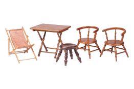 A pair of early 20th century wooden doll chairs, with hooped back and turned struts, on splayed legs