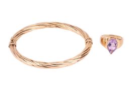 A 9ct gold amethyst ring and a 9ct gold bangle; the ring comprising a pear-shaped amethyst of light 