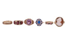 A group of six gem-set rings; The first an amethyst ring comprising an oval-cut amethyst of vivid pu