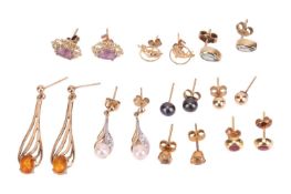 A group of nine pairs of earrings, including a pair of 9ct gold amber-set drop earrings, a pair of 9