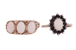 Two opal-set rings; The first an opal trilogy ring, comprising three oval opal cabochons, claw-set i
