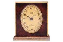 A Hermes of Paris, 8-day travel alarm clock, of architectural form with gilt brass body and faux tor