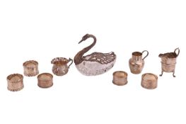 A small collection of silver items, including a silver-mounted glass bonbon dish in the form of a sw
