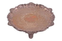 A Victorian silver salver, London 1875 by Henry Wilkinson & Sons, of circular form with scroll a