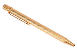 Cartier - a Must de Cartier gilt ballpoint pen of reeded design, clip with double-C logo, signed and