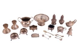 An aggregation of silver items; to include a pierced bonbon dish, a twin-handled sugar bowl, a pair 