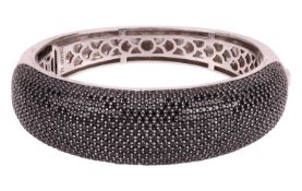 Ti Sento - a hinged gem-set bangle, the domed front pavé-set with black cubic zirconia, to a white m