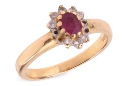 A ruby and diamond cluster ring, comprising a central ruby encircled by round brilliant cut diamonds