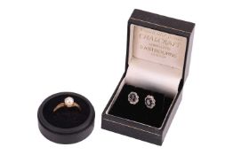 A pair of earrings and a ring; The earrings comprising an oval-cut sapphire of deep blue colour, enc