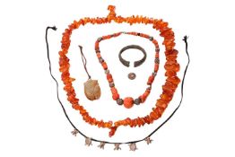 A mixed group of jewellery items comprising an amber bead necklace, a coral and white metal necklace