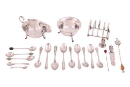 A small group of silver items including a sauce boat and sugar bowl on hoof feet, a toast rack, a co