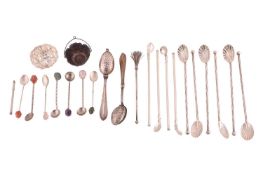 A set of six continental iced tea spoons with shell-shaped bowls, together with a silver tea straine